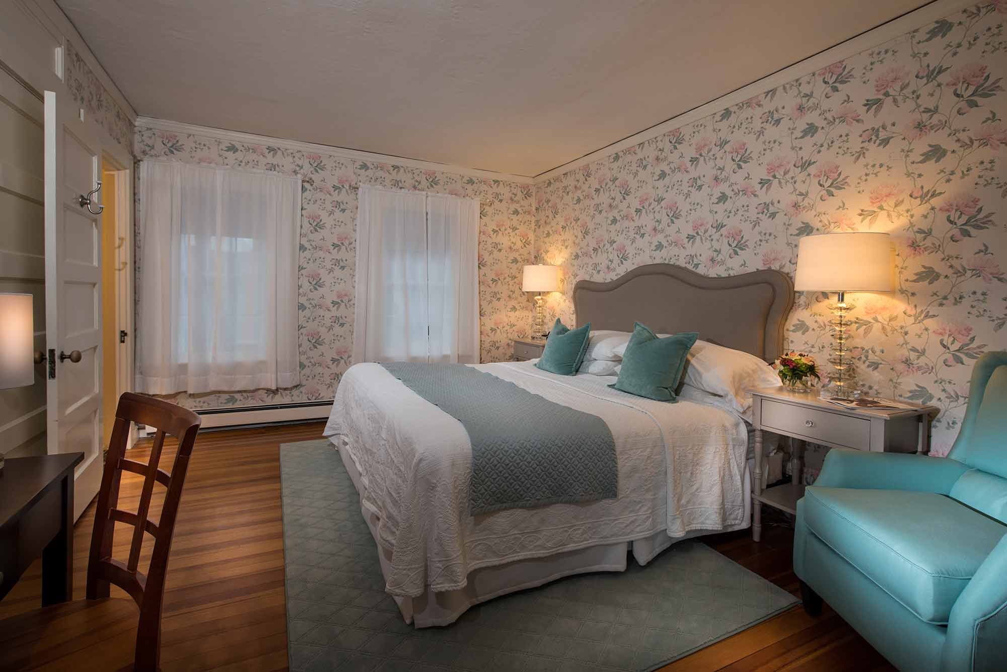 room 306 king bed in floral wall paper bedroom