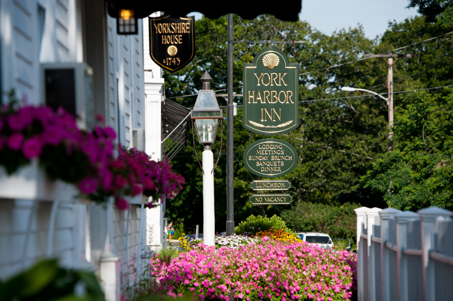 an outdoor photo from the Yorkshire house that shows the Yorkshire House sign and York Harbor Inn sign.
